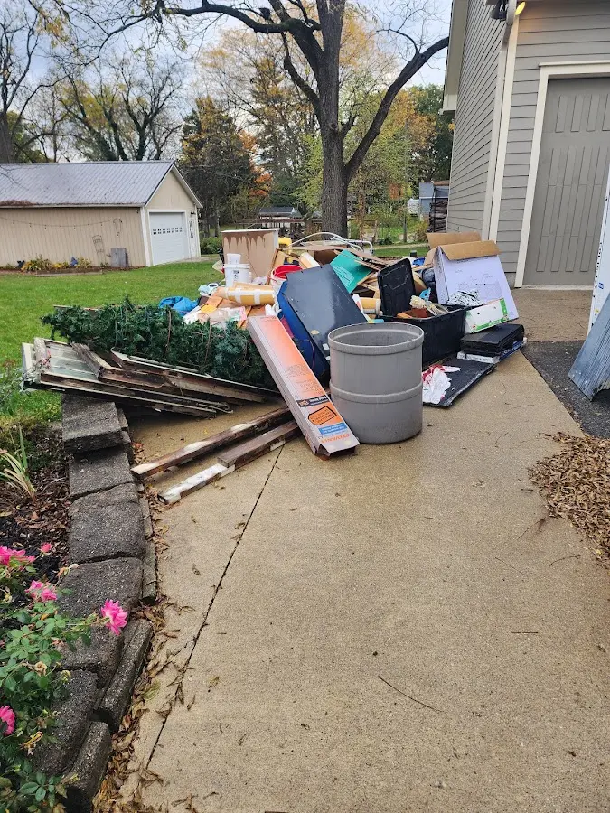 Dumpster being loaded with debris for Commercial Dumpster Rental in Childersburg